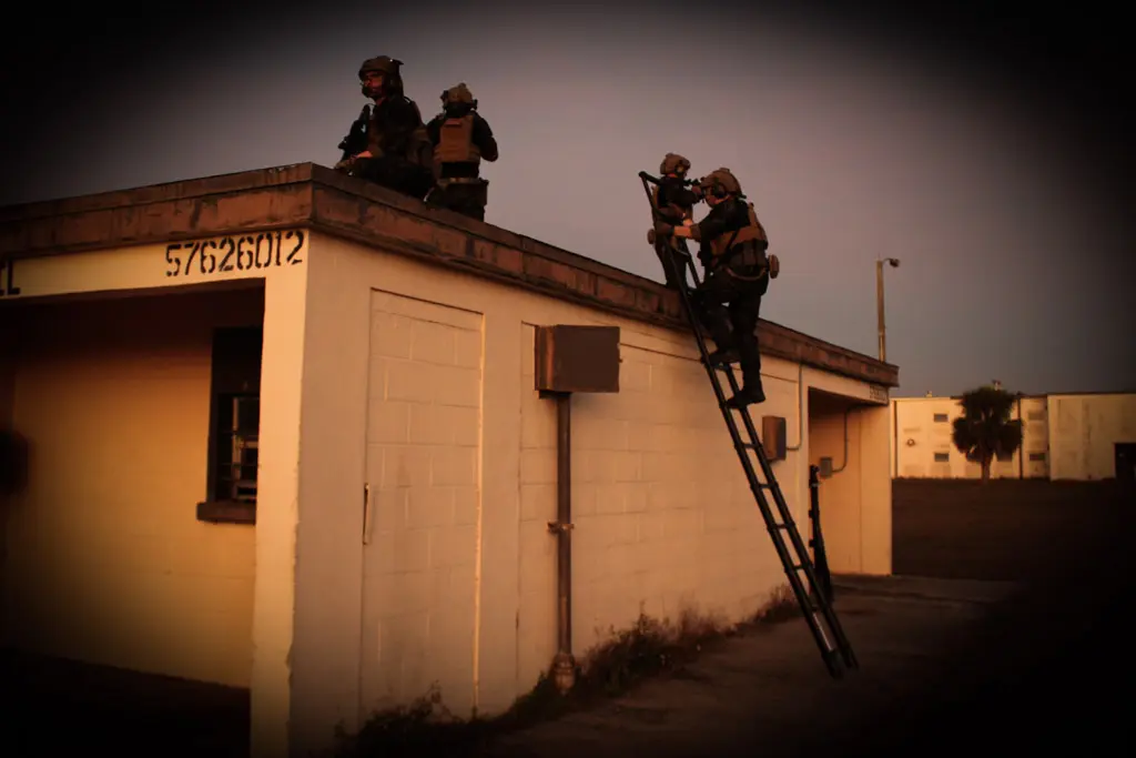 A group of men standing on top of a building.