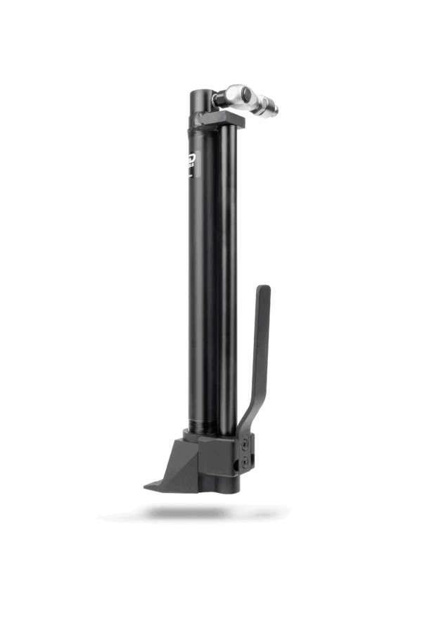 A black bicycle pump is standing up against the wall.